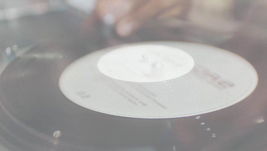 a close up of a record player with a blurry background