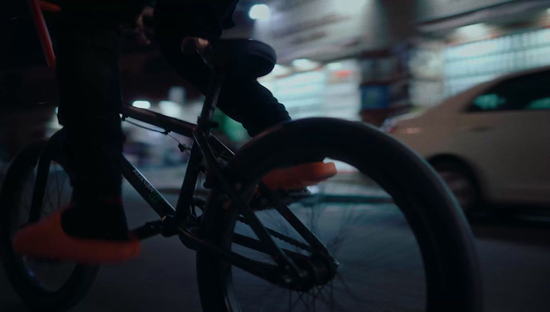 a person riding a bike on a city street