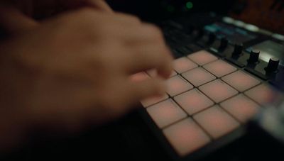 a hand is pressing buttons on a sound board