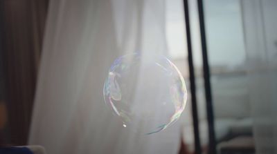 a close up of a soap bubble in front of a window