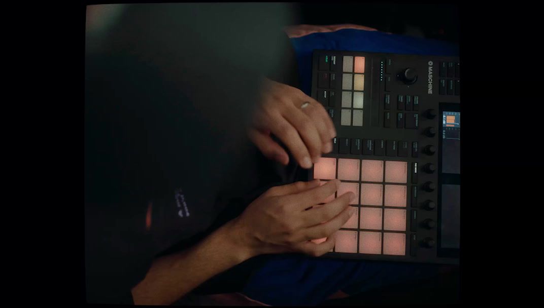 a person's hands on a control panel in a dark room