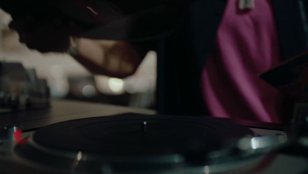 a close up of a record player playing a song