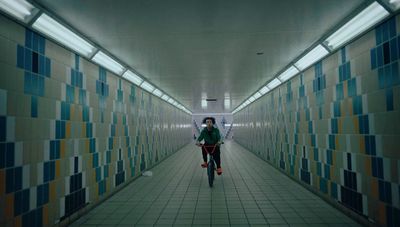 a man riding a bike down a long hallway