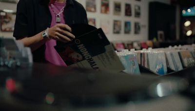 a woman standing in front of a record player