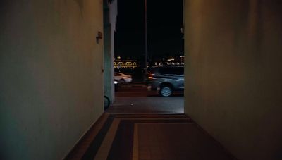 a car driving down a street at night