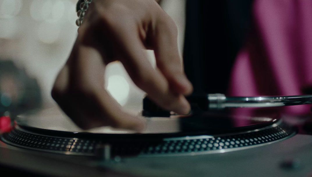 a person is playing a record on a turntable