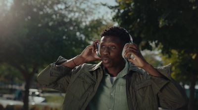 a man talking on a cell phone while wearing a jacket