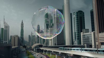 a large bubble floating in the air over a city