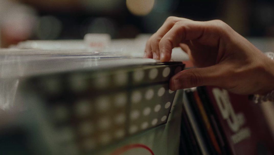 a person's hand on top of a shelf