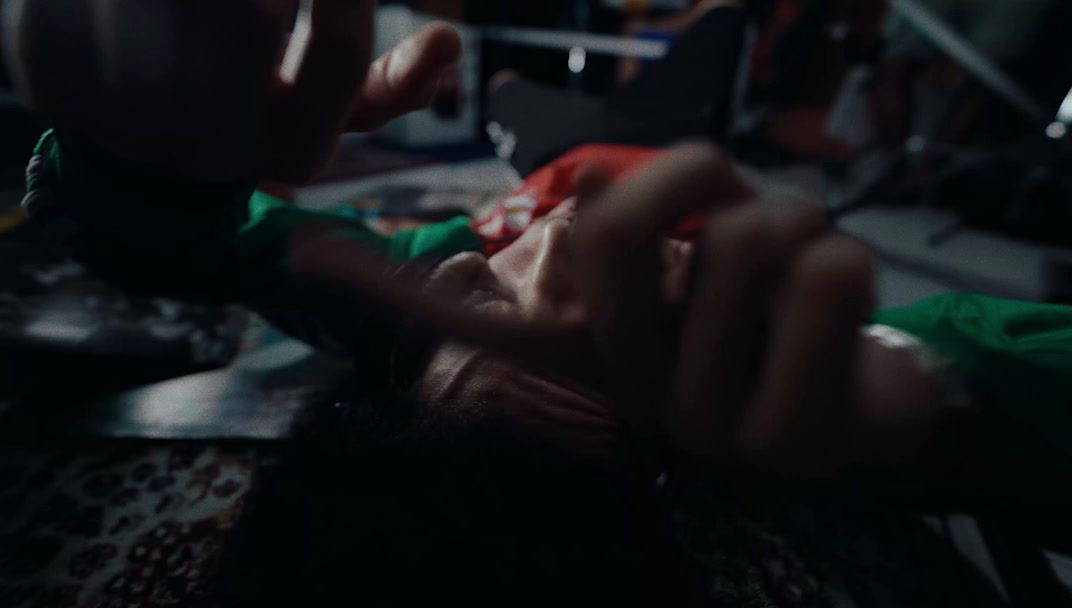 a woman getting her teeth brushed by a dentist