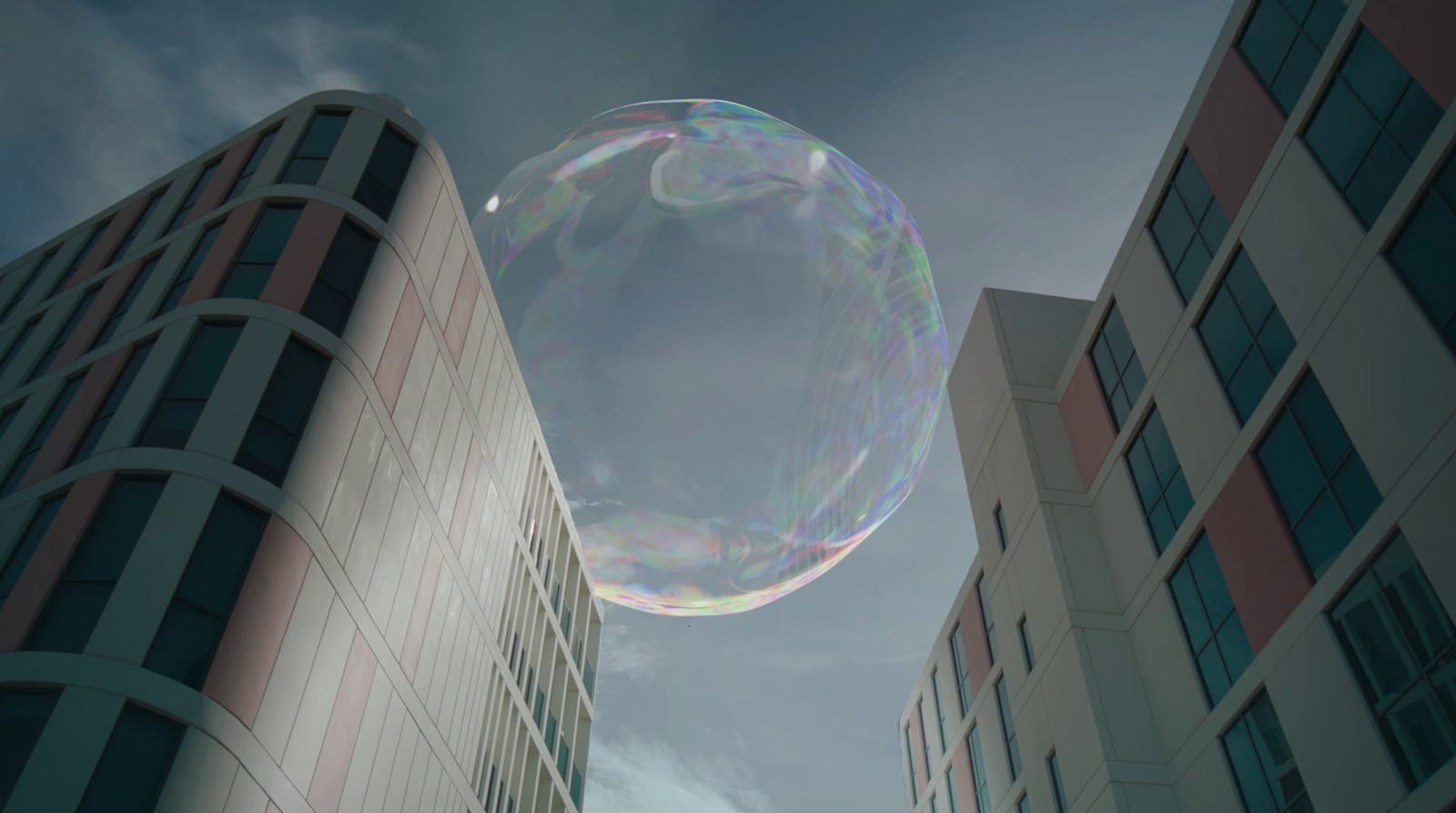 a large bubble floating in the air between two buildings