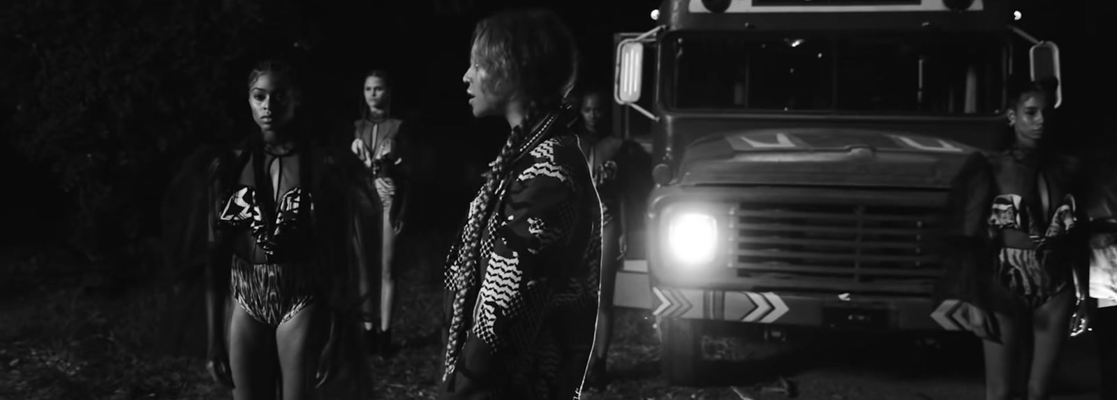 a group of people standing in front of a truck