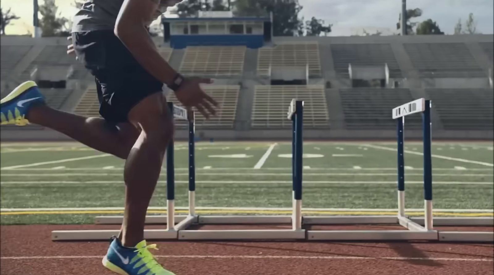 a man running on a track in a stadium