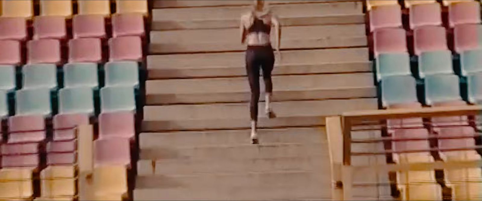 a woman standing on a set of stairs in a stadium