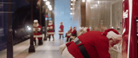 a group of people dressed as santa claus in a hallway