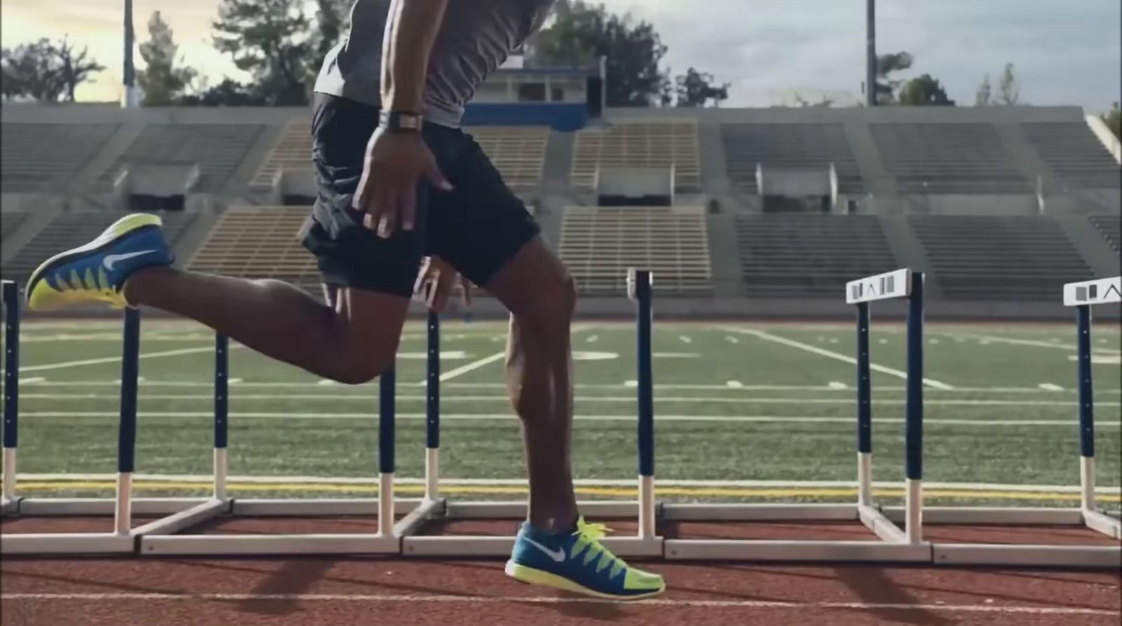 a man running on a track in a stadium