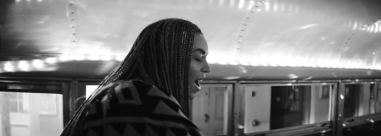 a black and white photo of a woman in a train