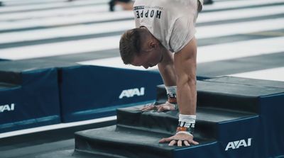 a man doing a handstand on a set of stairs