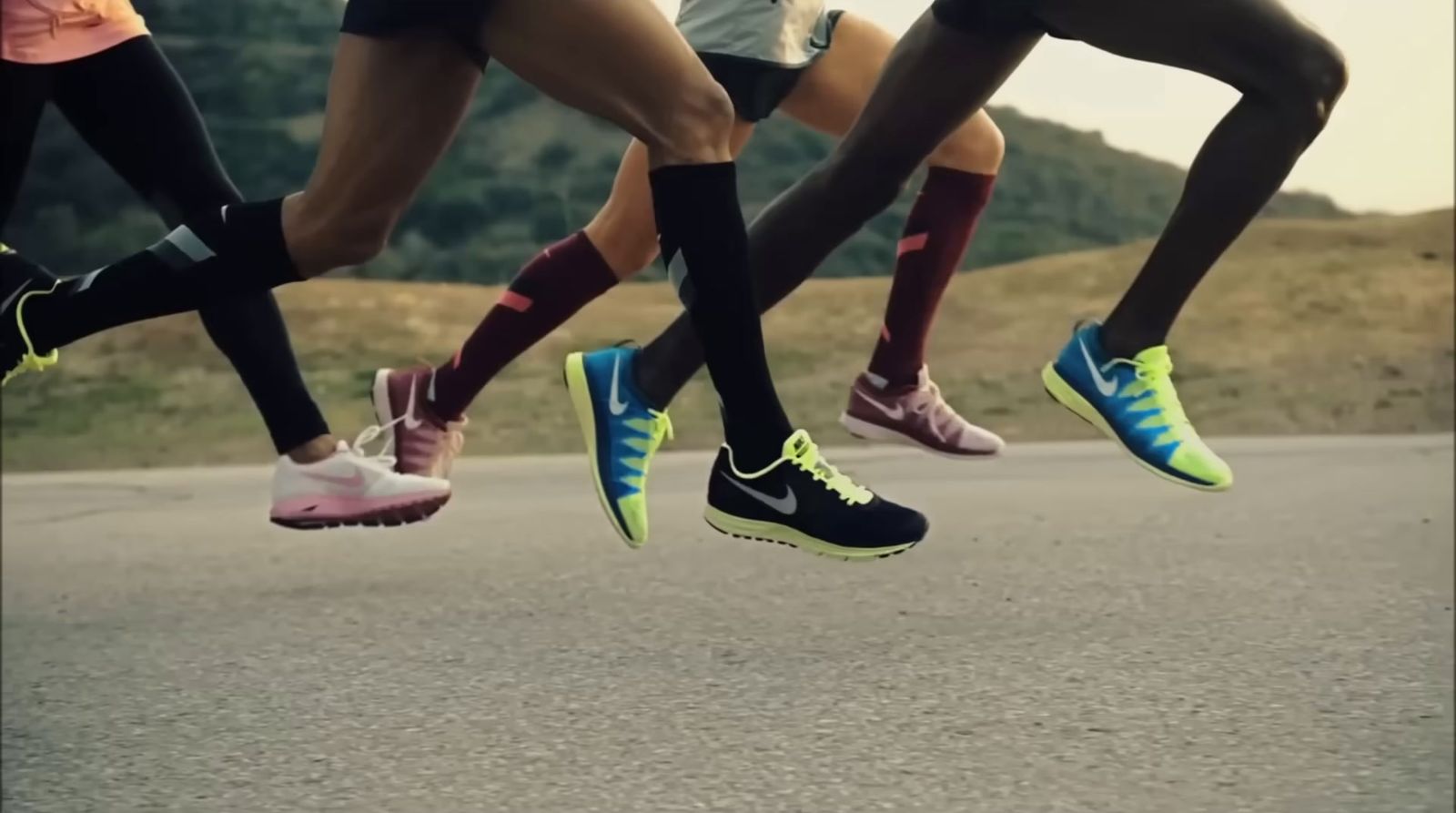 a group of people running down a street