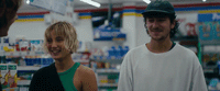 a man and a woman standing in a store