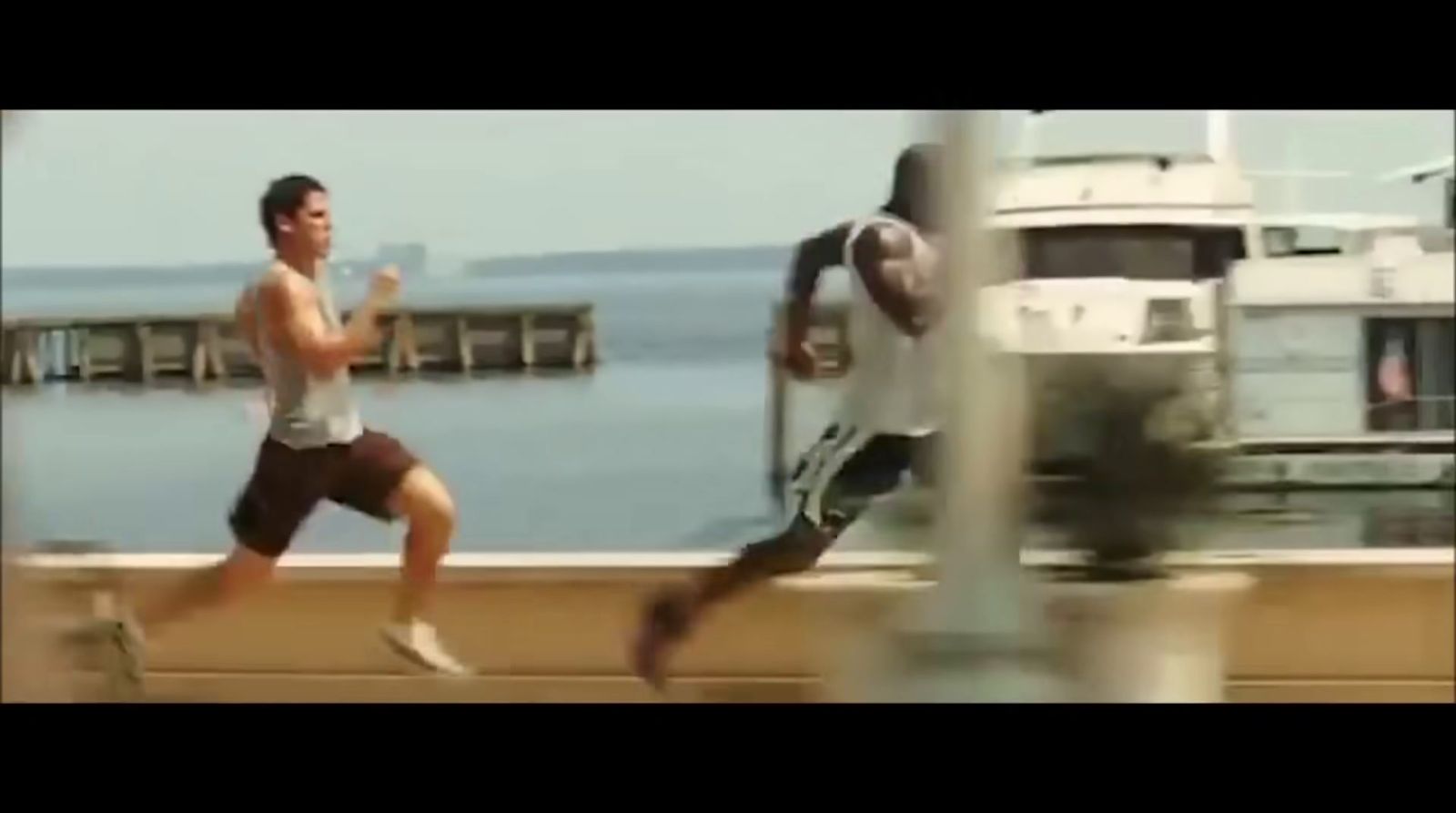 a couple of men running across a bridge