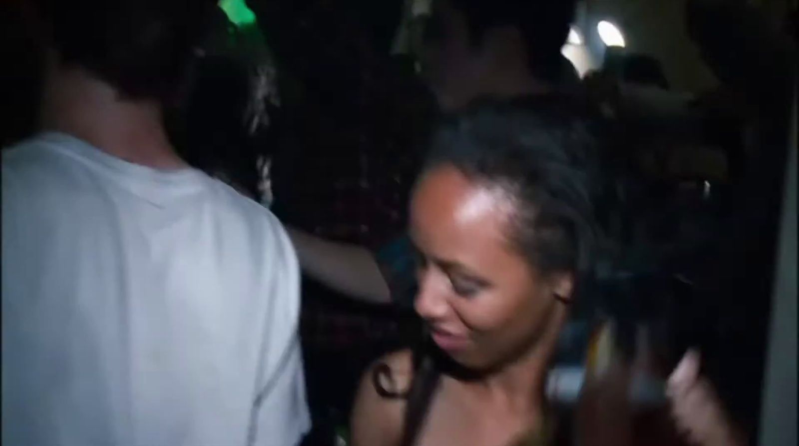 a woman standing next to a man at a party