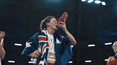 a woman holding a pair of shoes up to her face