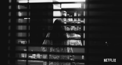 a woman standing in front of a window