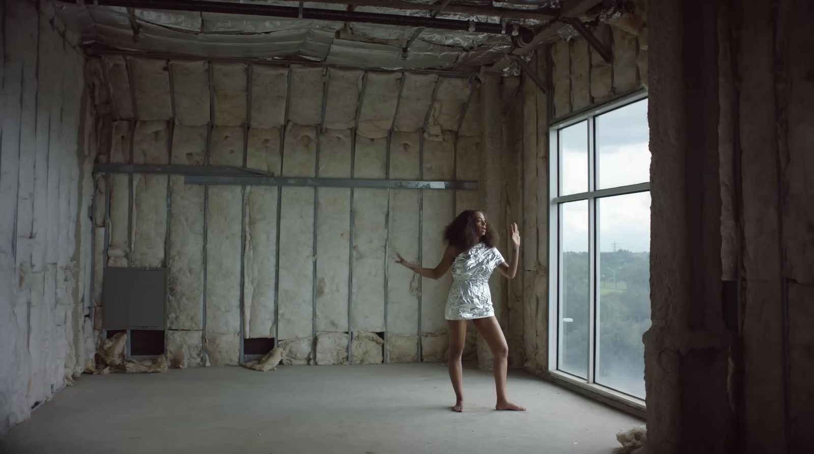 a woman standing in a room with a window