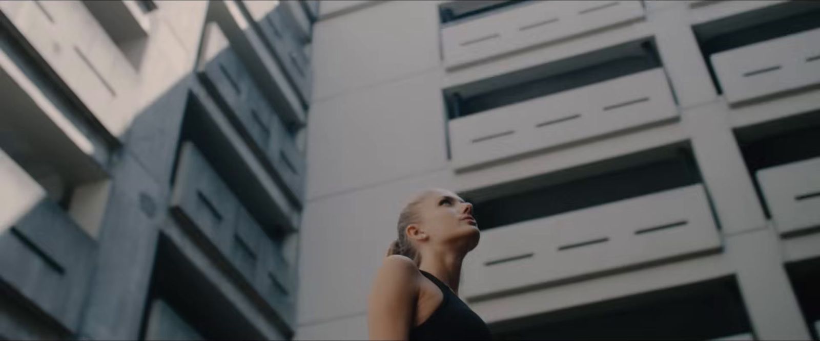 a woman standing in front of a tall building