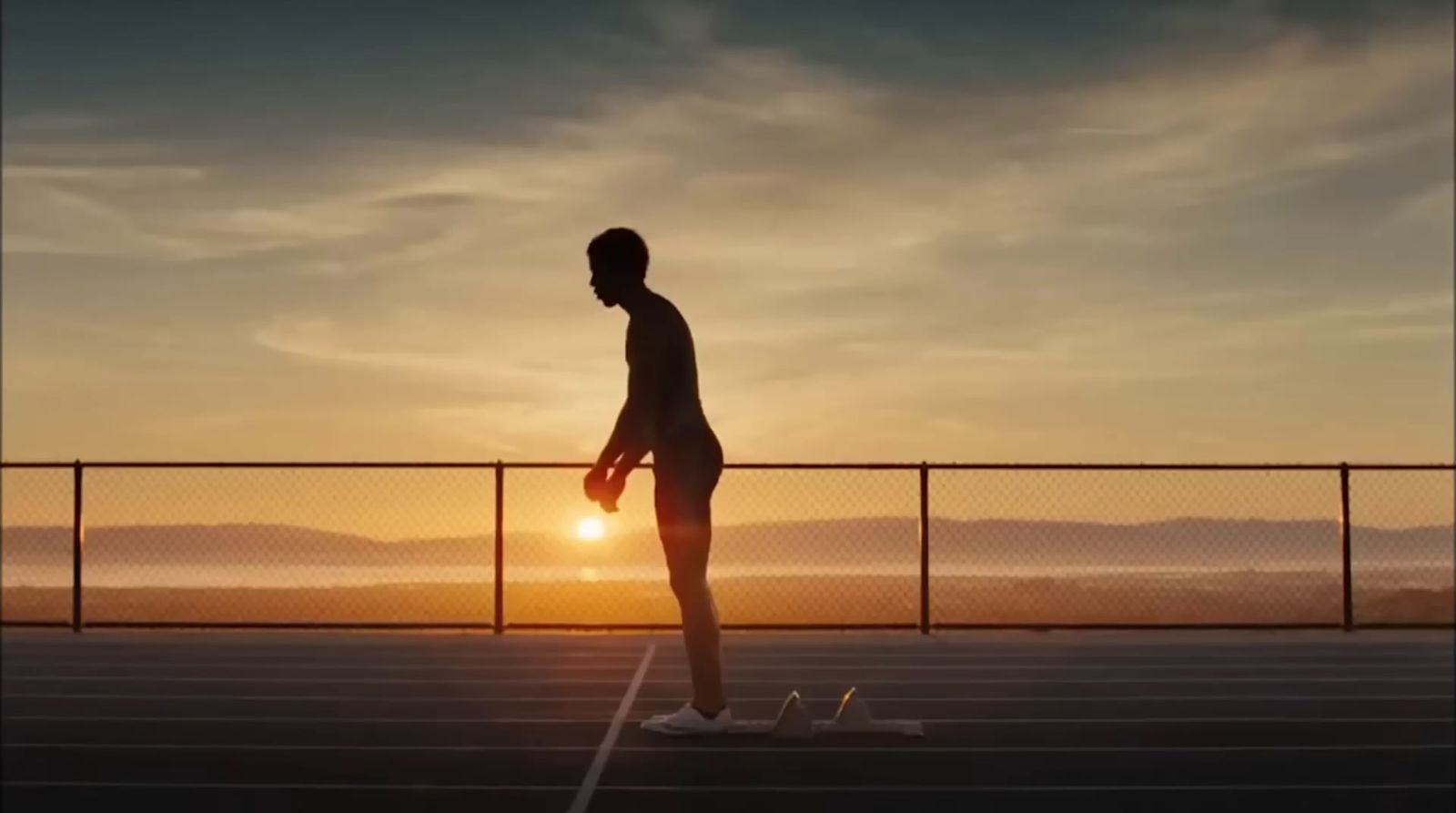 a man standing on top of a tennis court holding a racquet