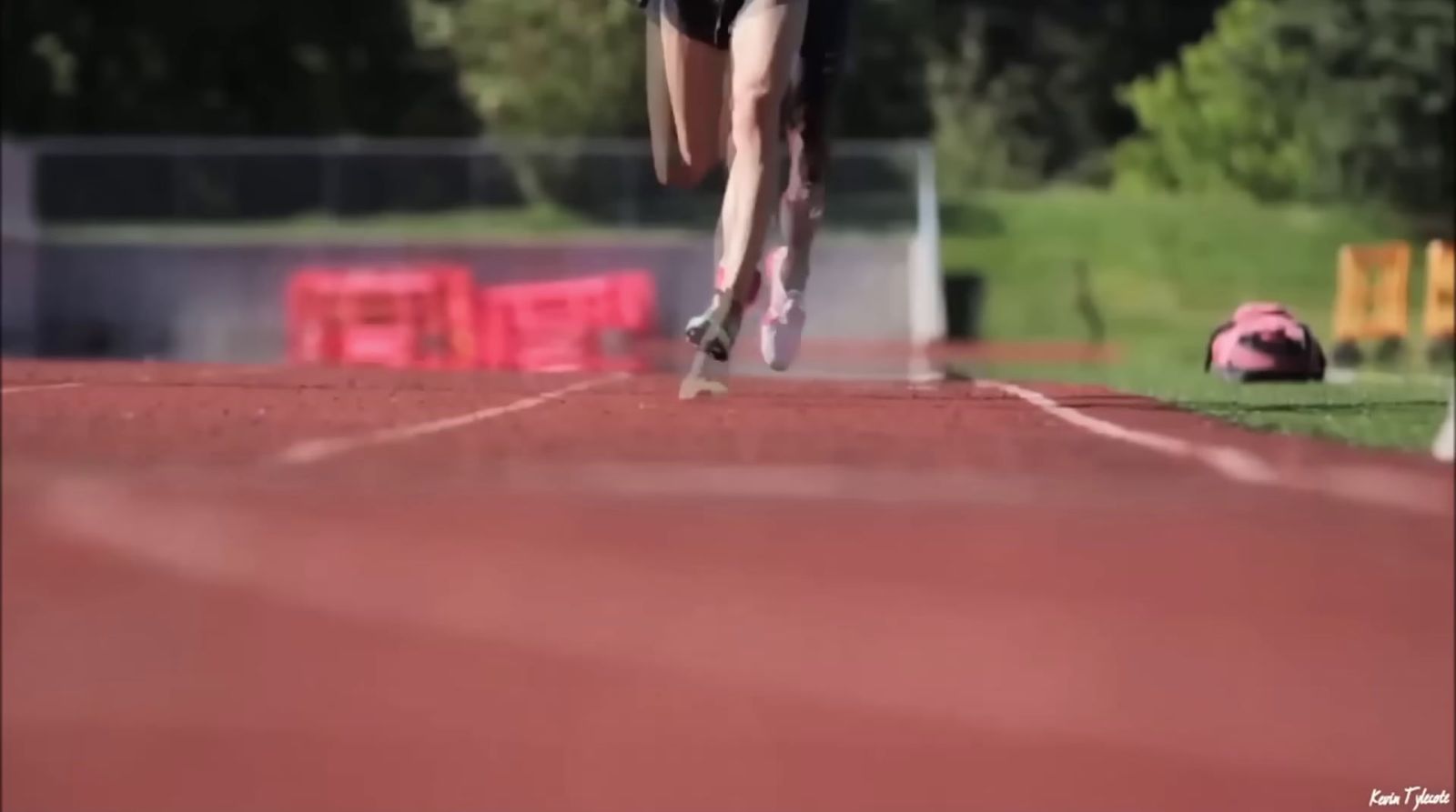 a person running on a track in a field