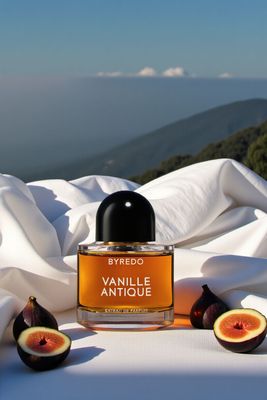 a bottle of perfume sitting on top of a white sheet