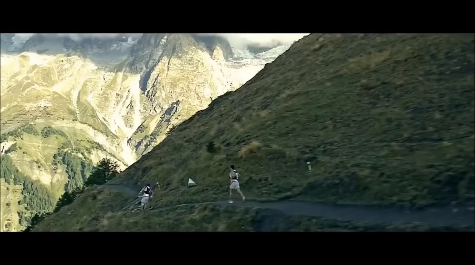 a group of people walking up the side of a mountain