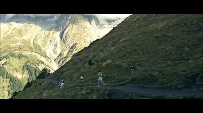 a group of people walking up the side of a mountain