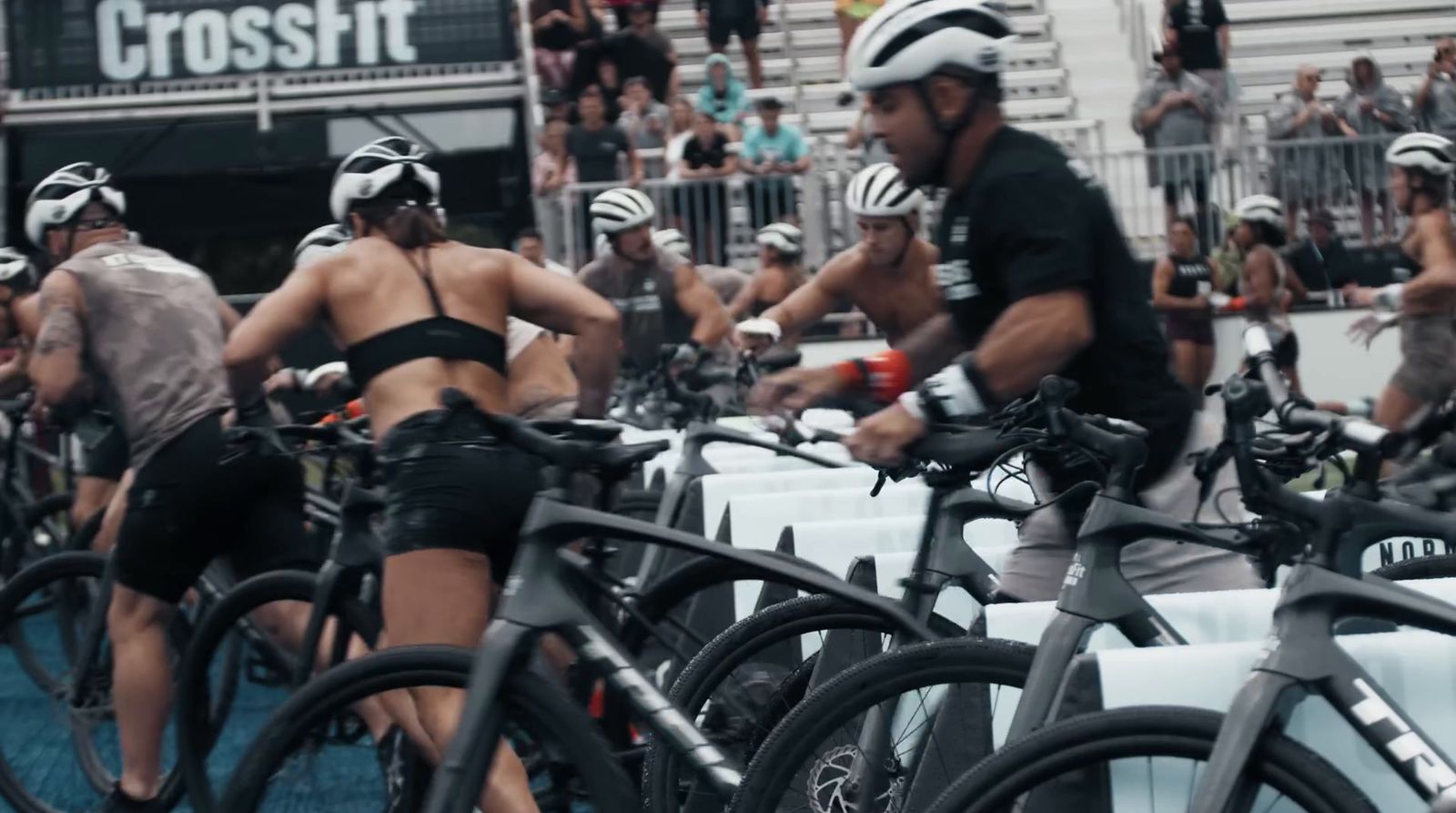 a group of people riding bikes down a street