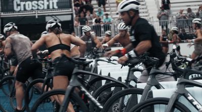 a group of people riding bikes down a street