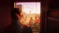 a woman looking out a window at a group of people