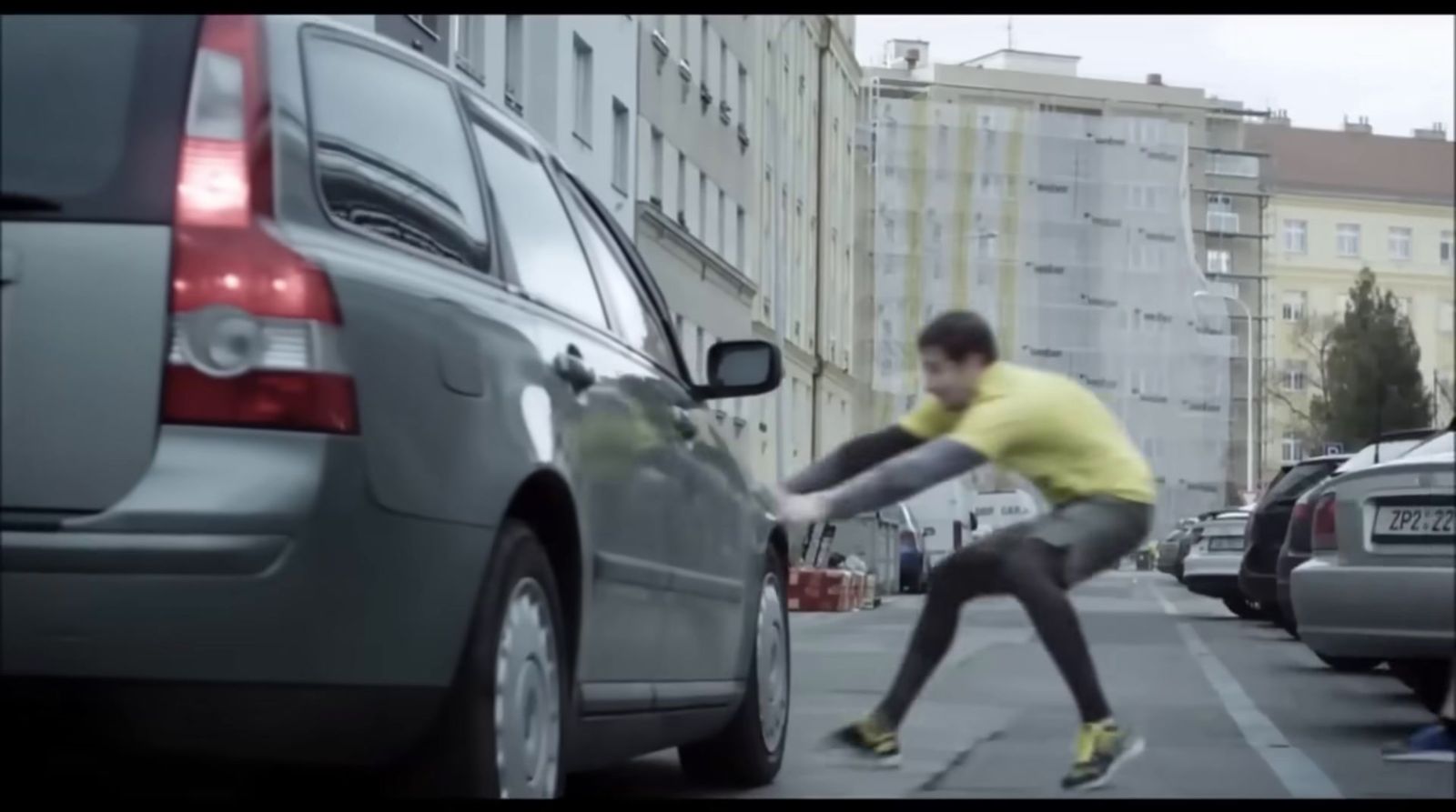 a man in a yellow shirt is doing tricks on a skateboard