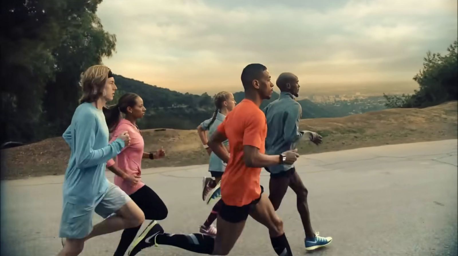 a group of people running down a road