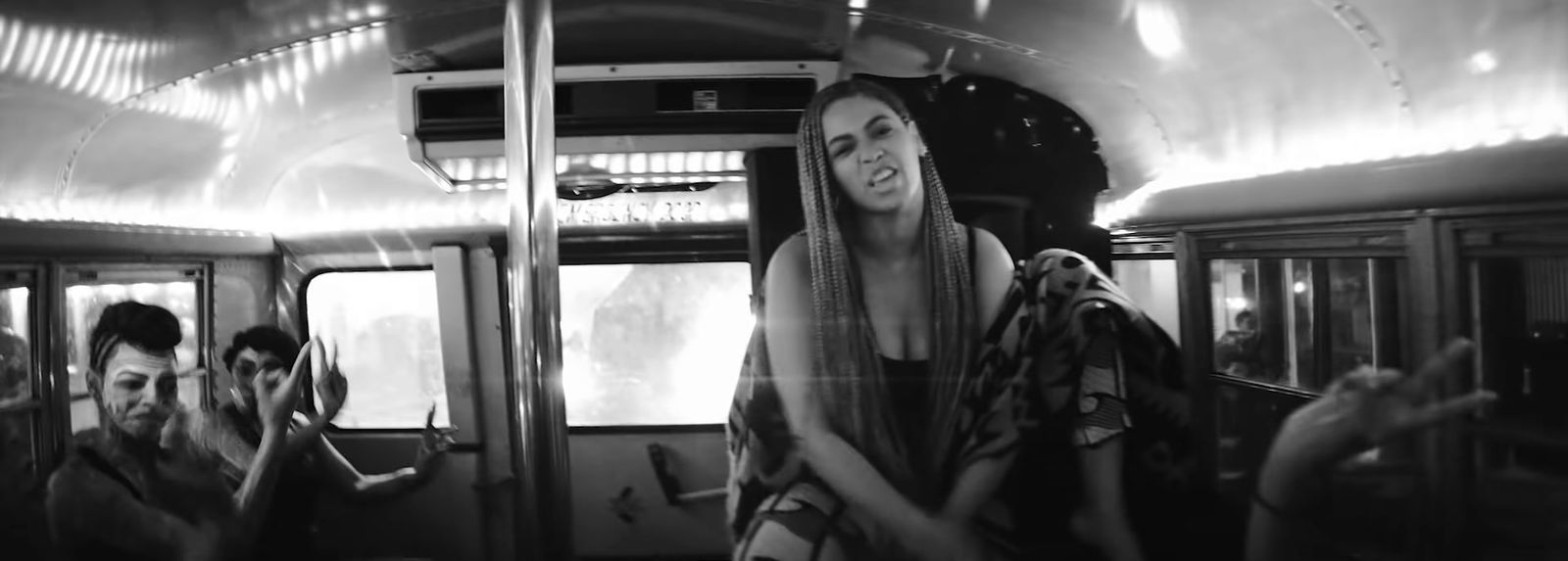 a black and white photo of a woman on a bus