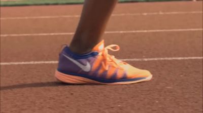 a close up of a person's shoe on a tennis court