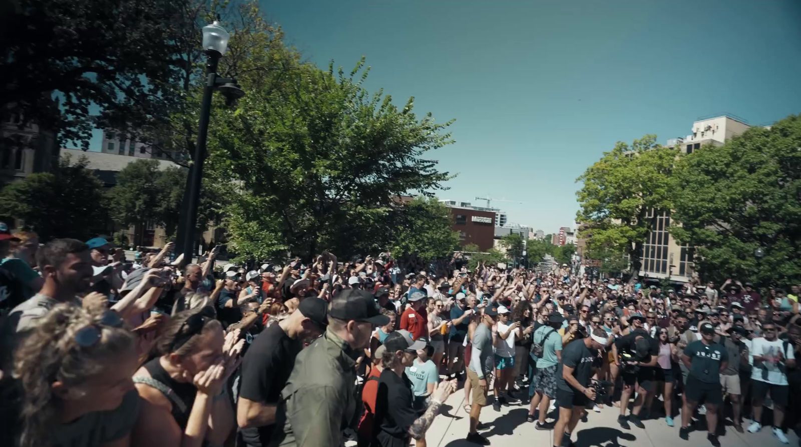 a large group of people walking down a street