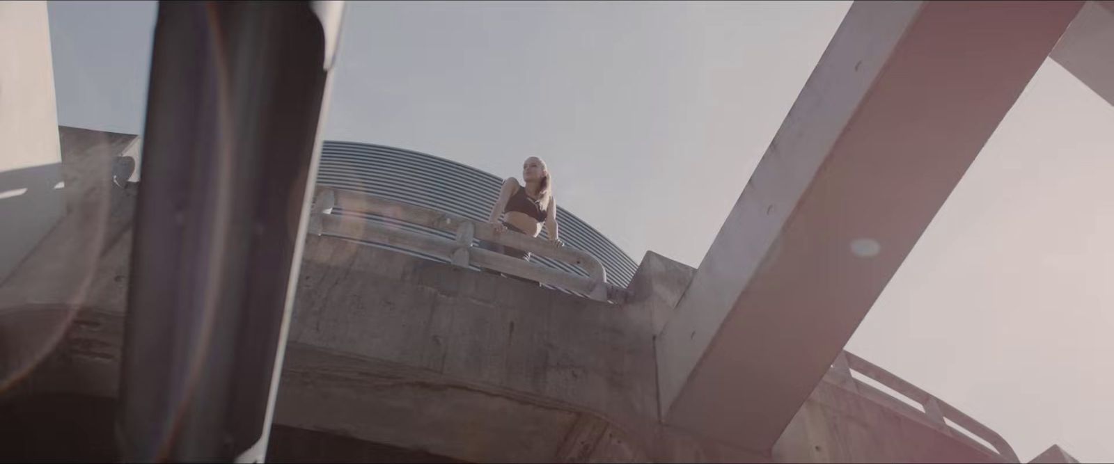 a person standing on a ledge of a building