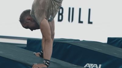 a man doing a handstand on a trampoline