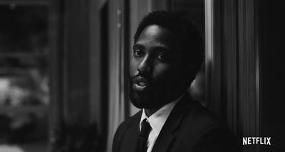 a black and white photo of a man in a suit