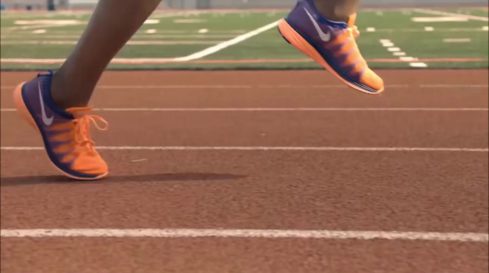 a close up of a person running on a track