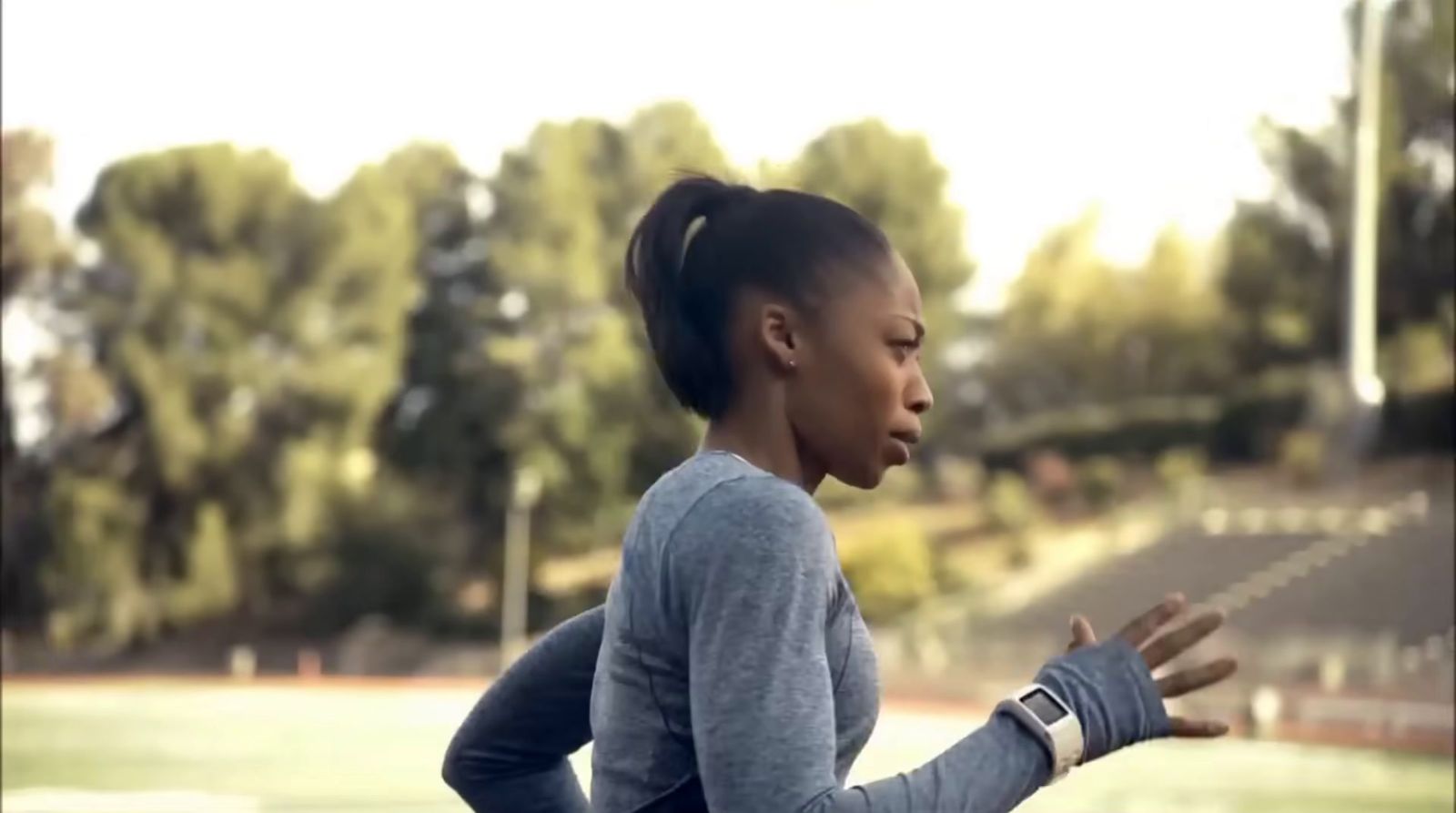 a woman with a ponytail standing on a tennis court