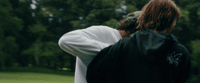 a man in a white shirt and a black backpack