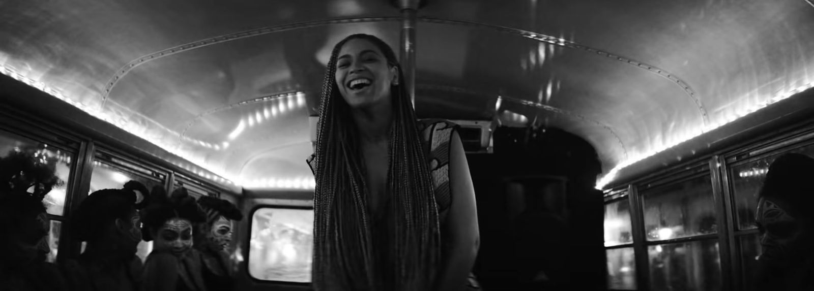 a woman with long hair standing on a bus